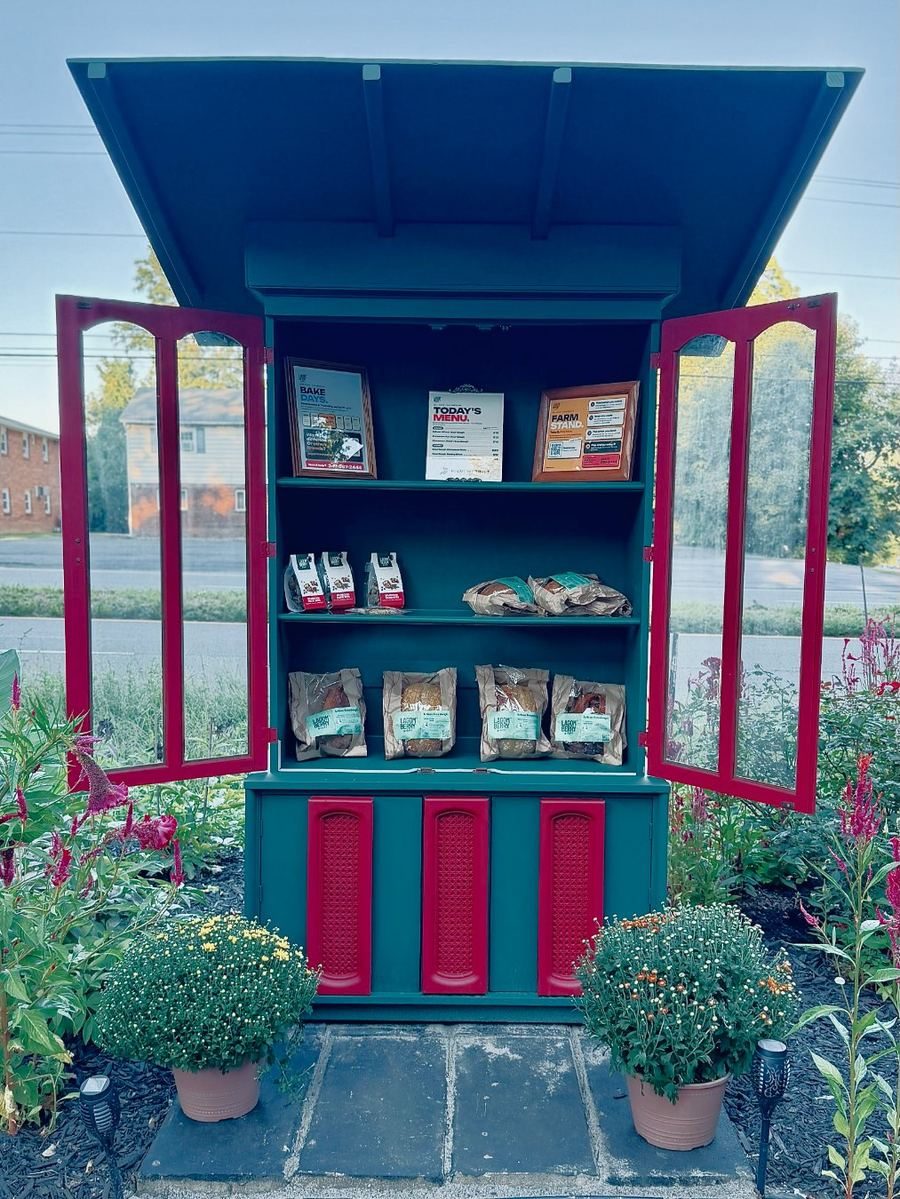 The Lagomberry farm stand on Route 9W, New Windsor, doors open with sourdough loaves and pastry on the shelves