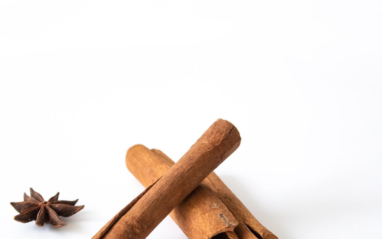 Cinnamon sticks and star anise on a white surface