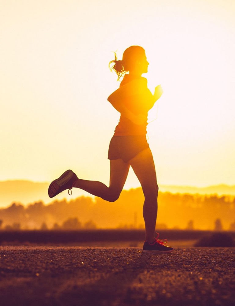 A woman running at sunset