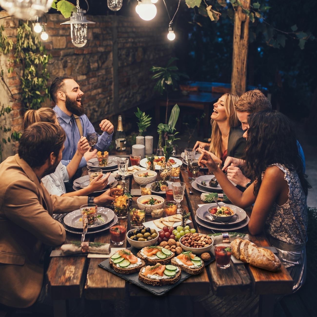 Friends sharing a meal around a long table