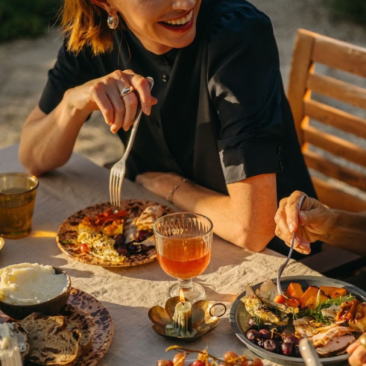 A woman savouring a plate of food