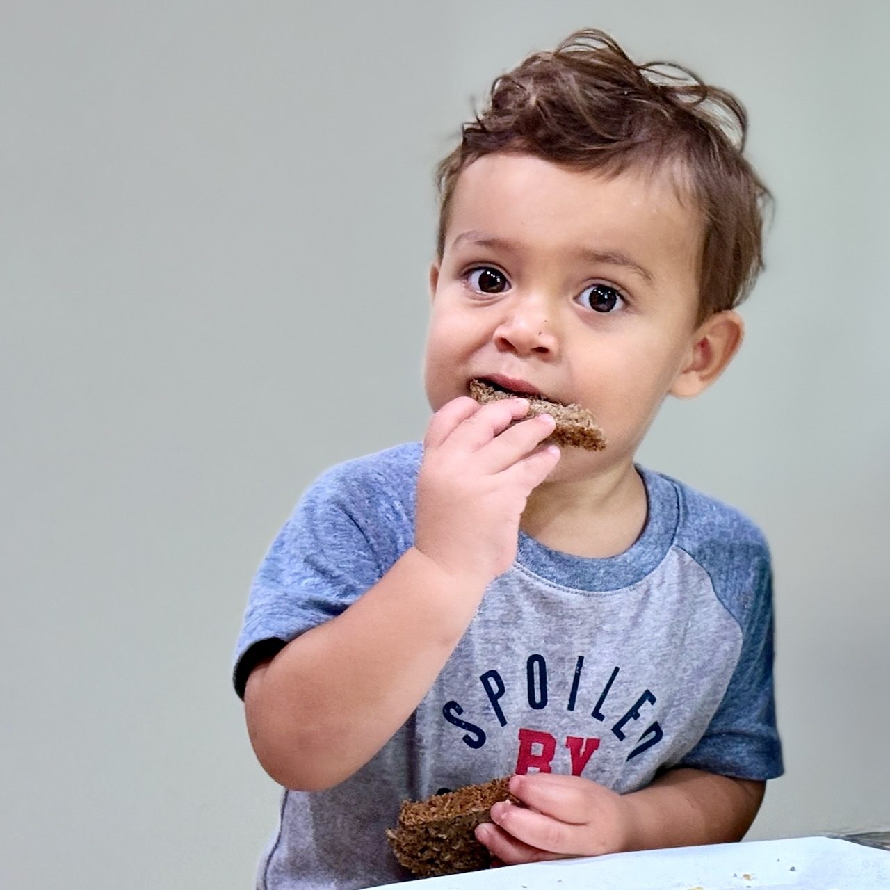 A toddler eating a slice of Lagomberry rye