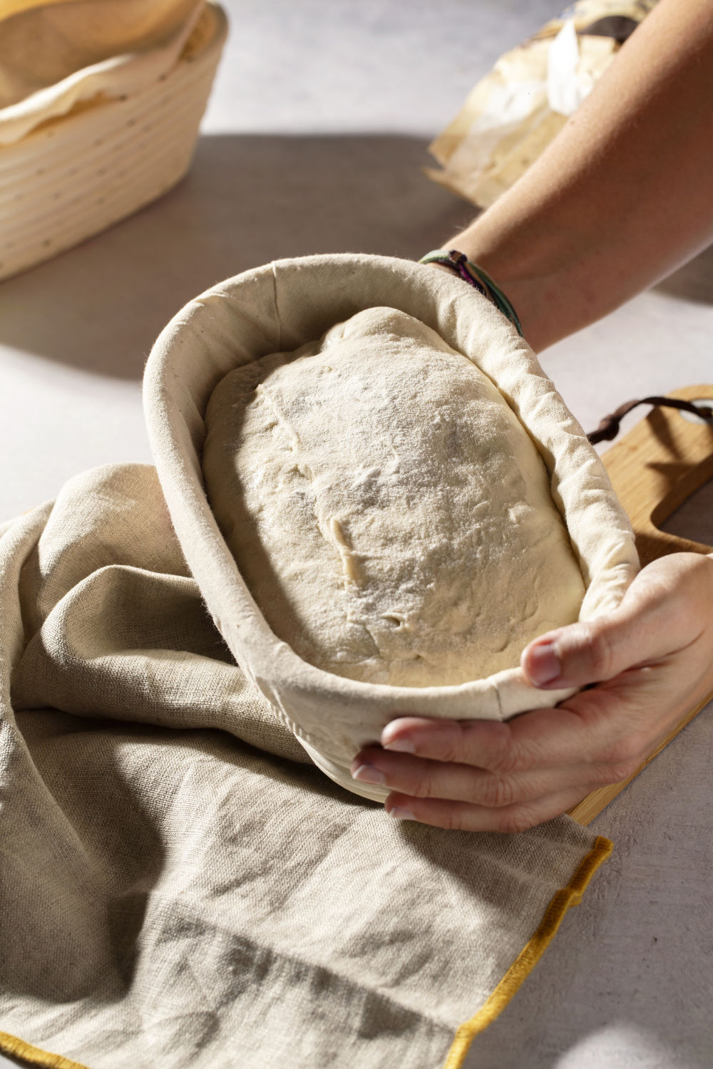 Sourdough dough proofing in a linen-lined banneton