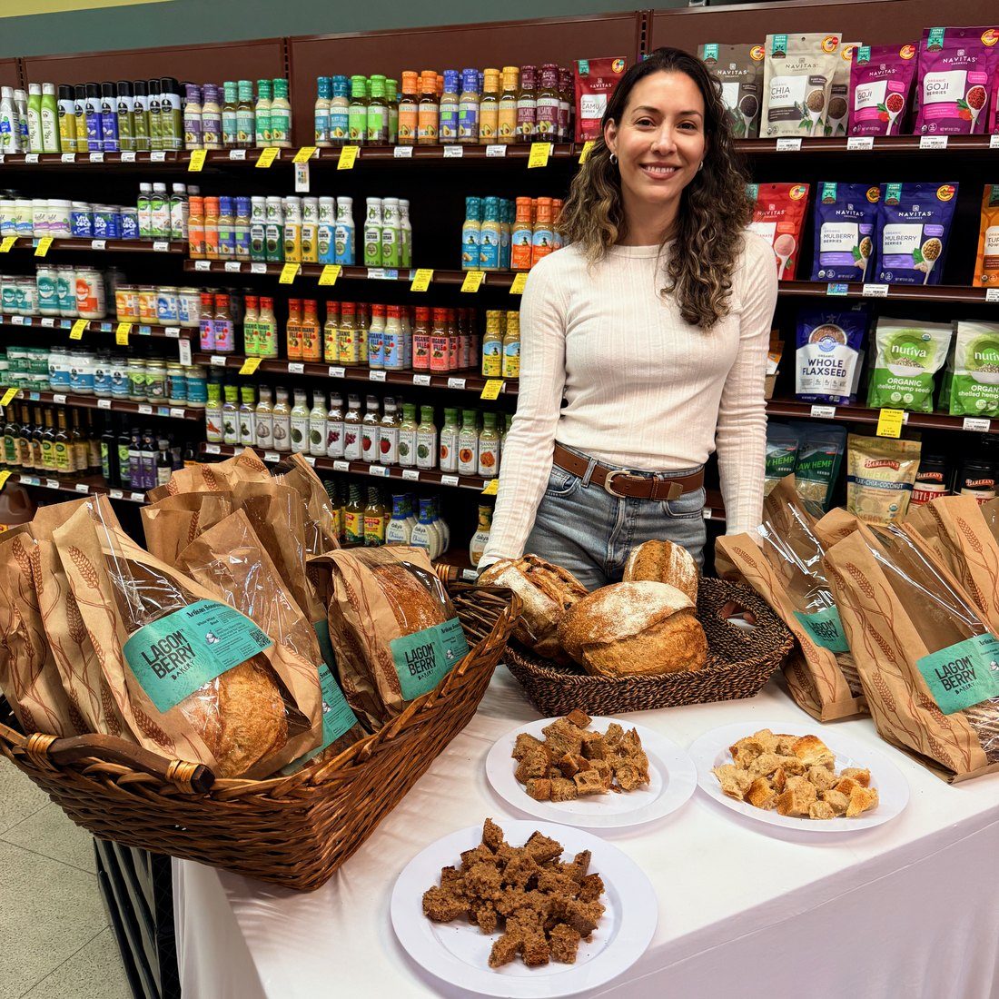 Lorraine behind a table of Lagomberry loaves at a tasting