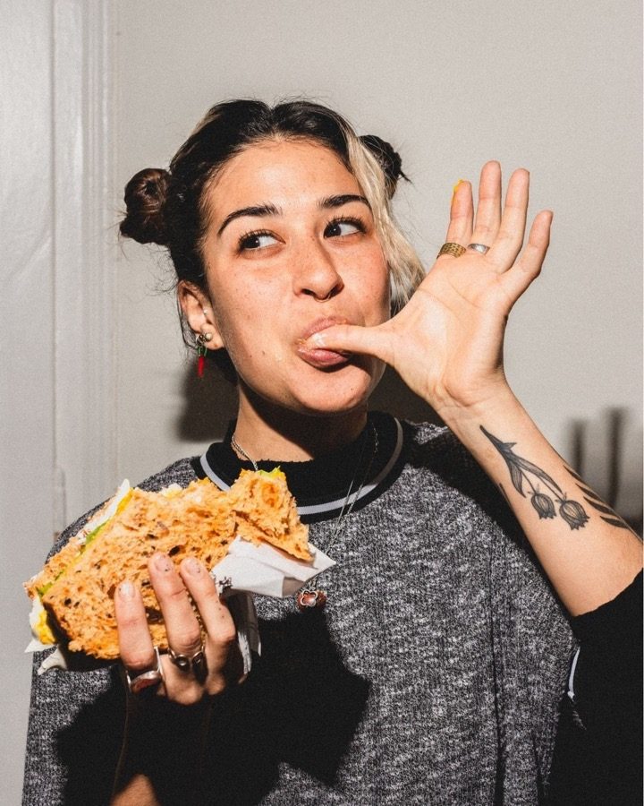 A woman finishing the last of something sweet